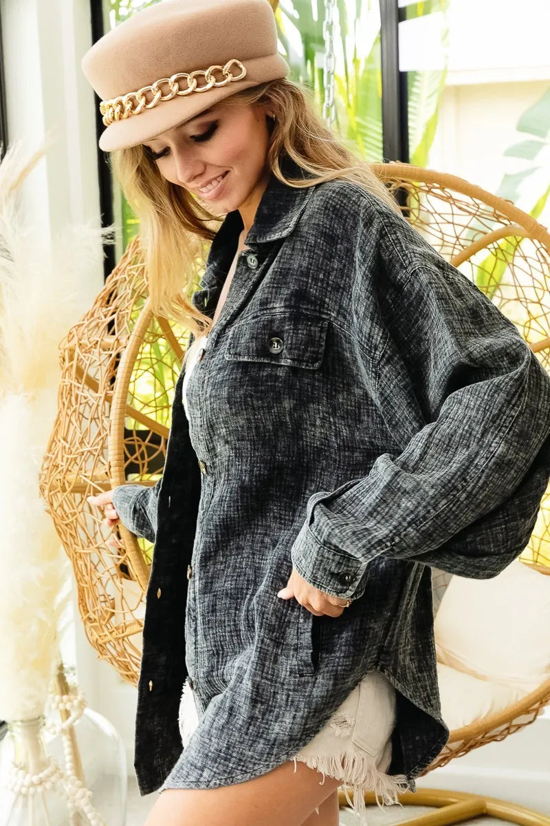 Woman wearing a denim jacket and beige hat in a casual setting