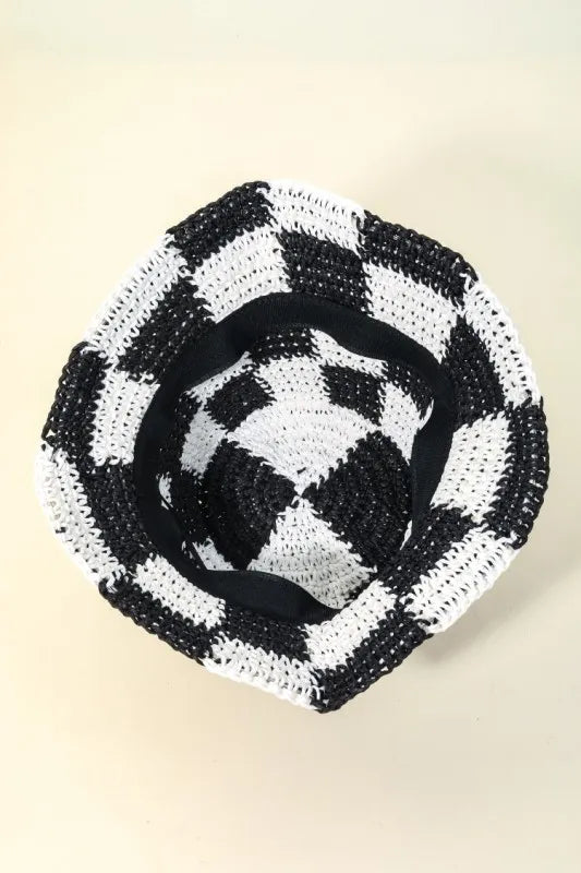 Black and white checkered woven basket on a beige background