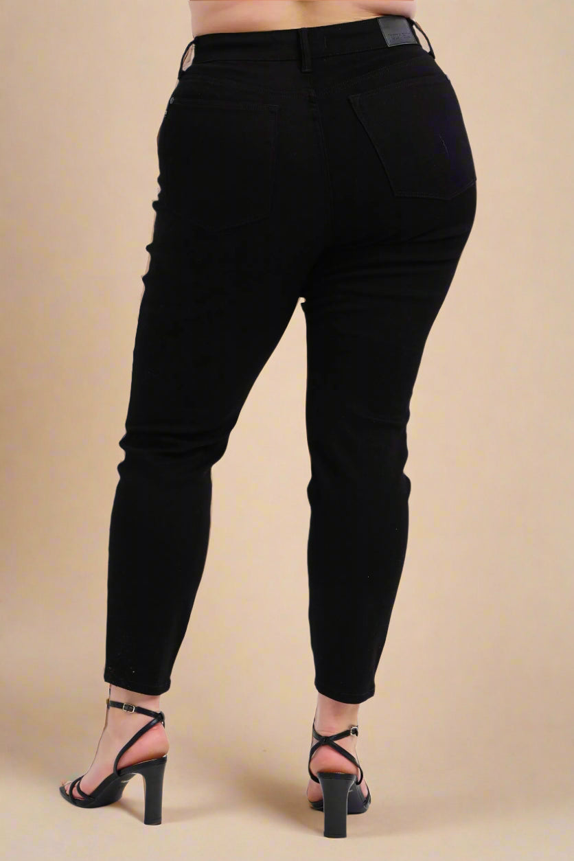 Black pants worn by a person on a white background