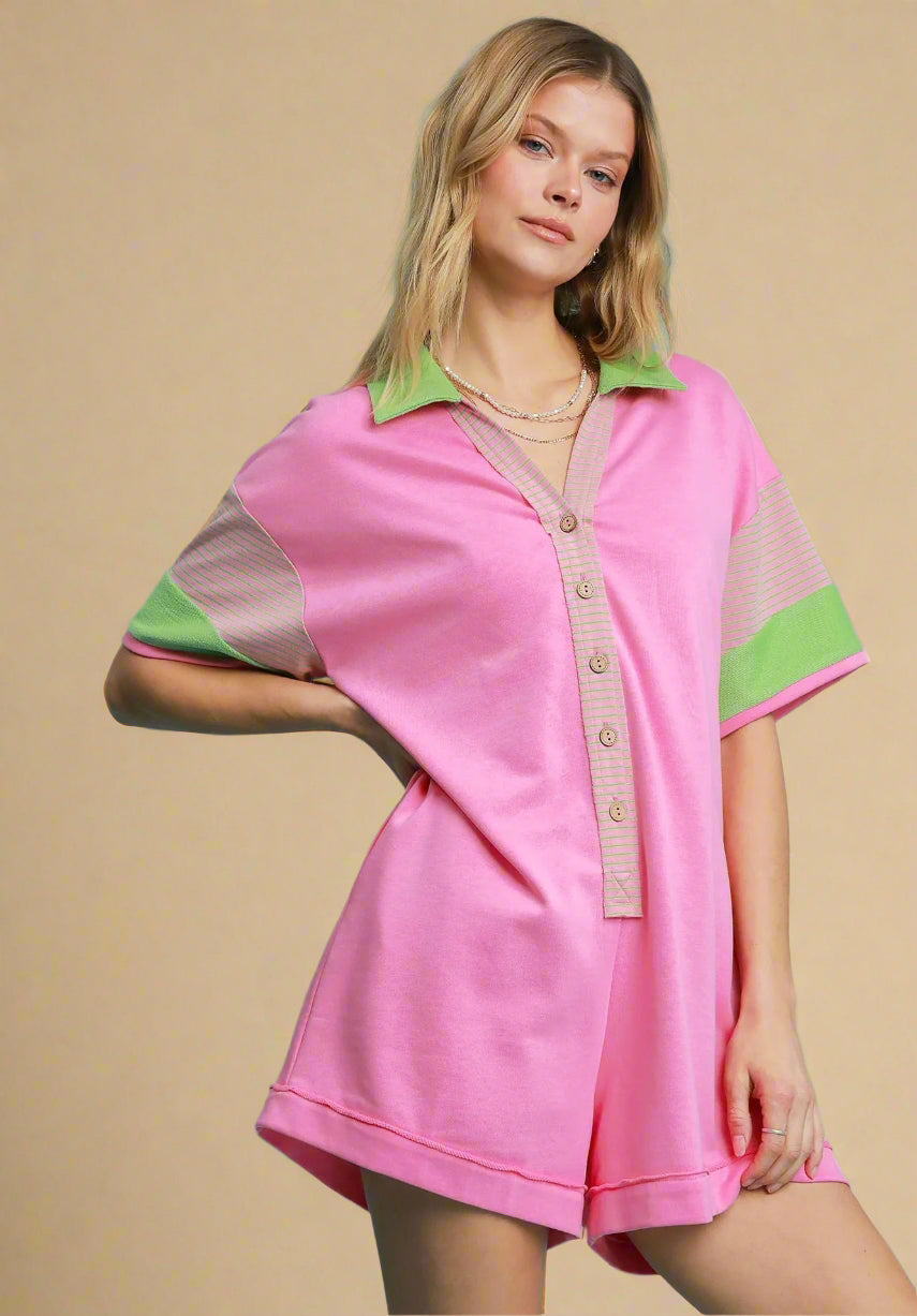 Woman wearing a pink dress with green accents on a beige background