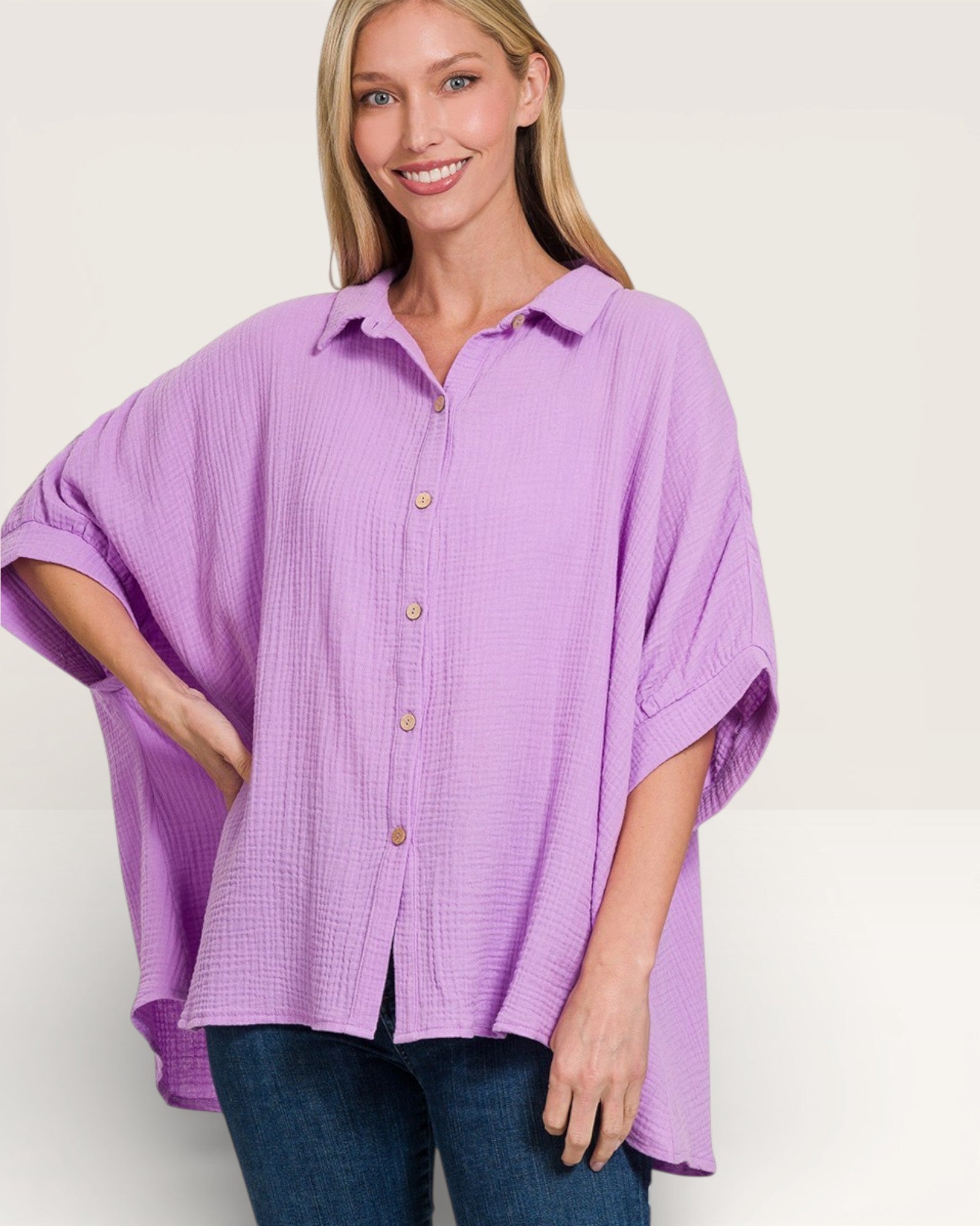 Woman wearing a purple button-up shirt on a white background