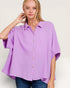 Woman wearing a purple button-up shirt on a white background
