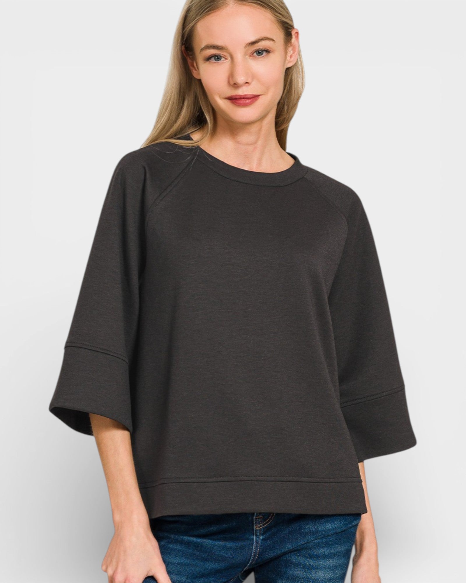 Woman wearing a black oversized sweater on a white background