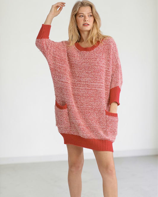 Woman wearing a red knitted dress against a white background