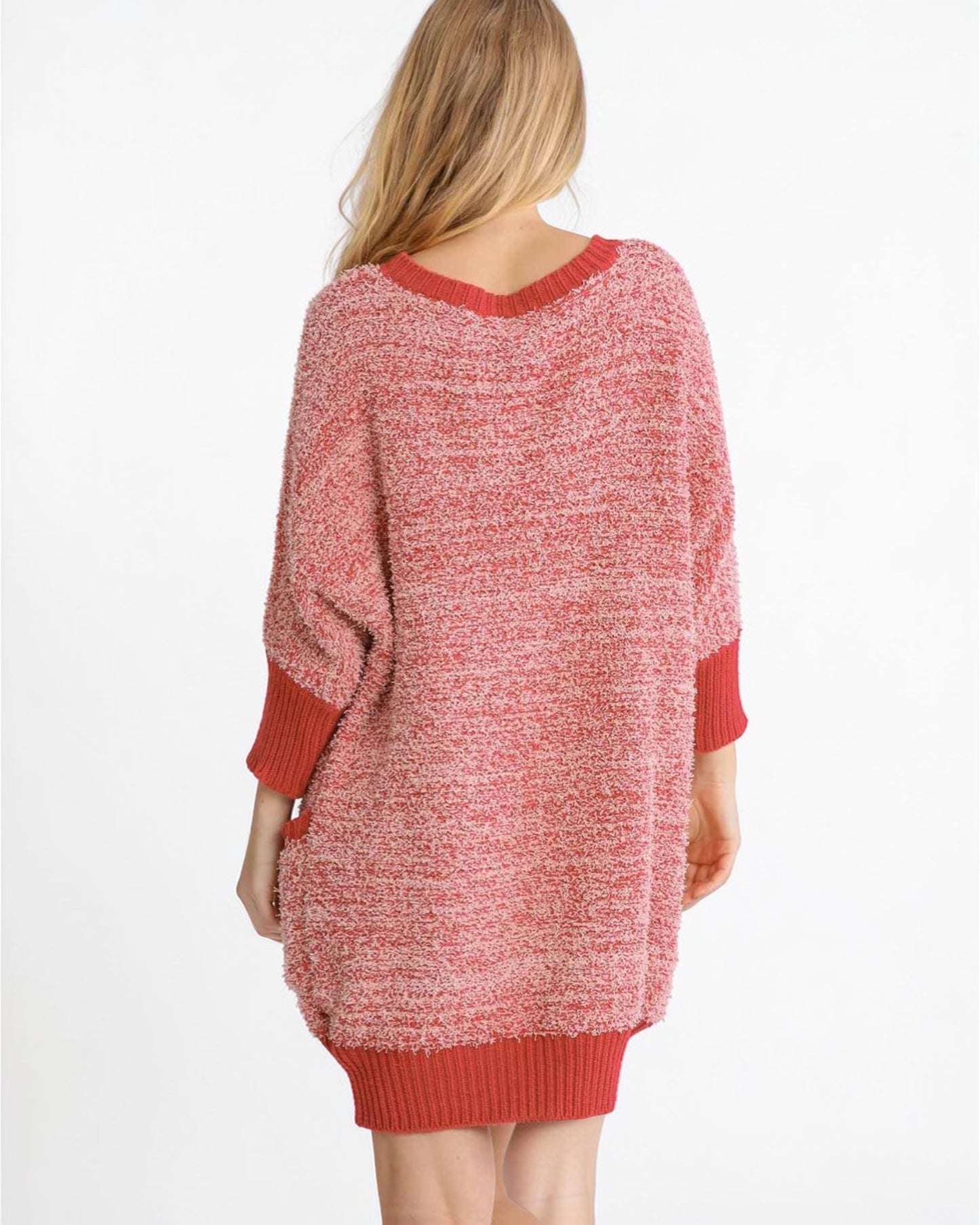 Red sweater dress worn by a person on a white background
