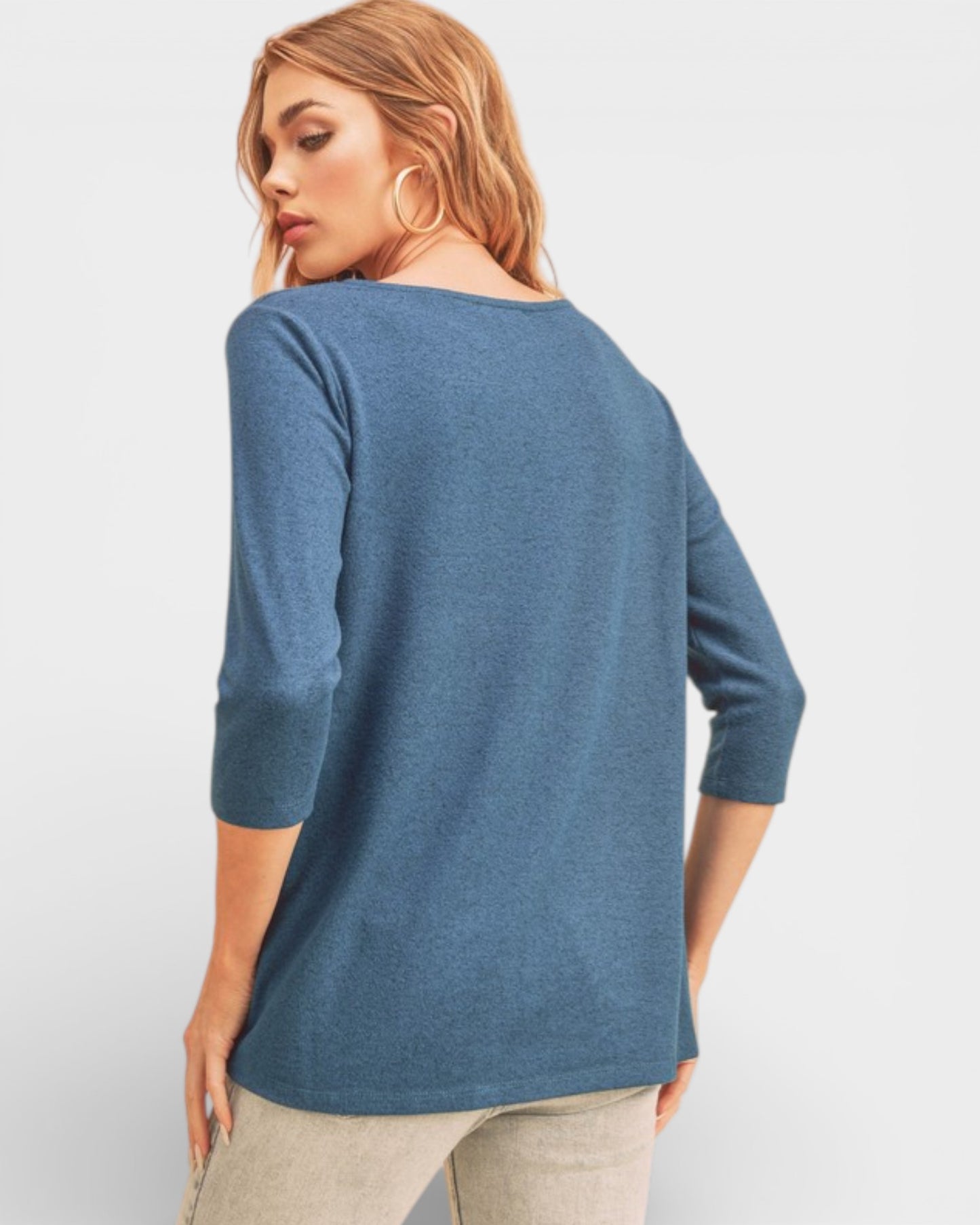 Woman wearing a blue sweater on a light gray background