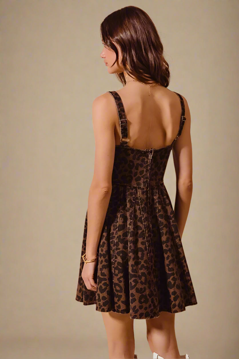Woman wearing a leopard print dress against a beige background