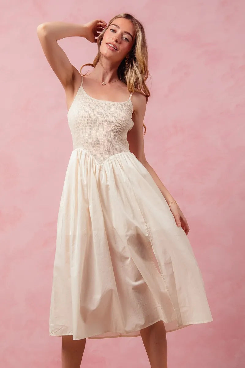 Woman wearing a white dress against a pink background
