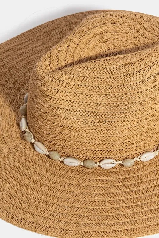 Beige straw hat with a decorative band on a white background