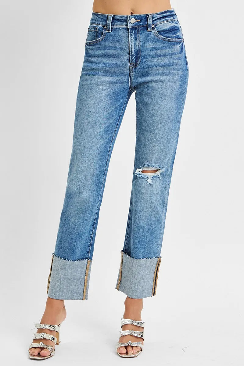 Blue jeans with distressed details on a white background