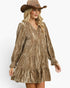 A woman wearing a bronze-brown tiered long-sleeve dress with a crinkled metallic texture, paired with a matching brown cowboy hat, against a plain white background.
