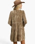 A woman shown from the back wearing a brown tiered dress with a textured, crinkled metallic finish and a matching brown woven hat, set against a plain white studio background.