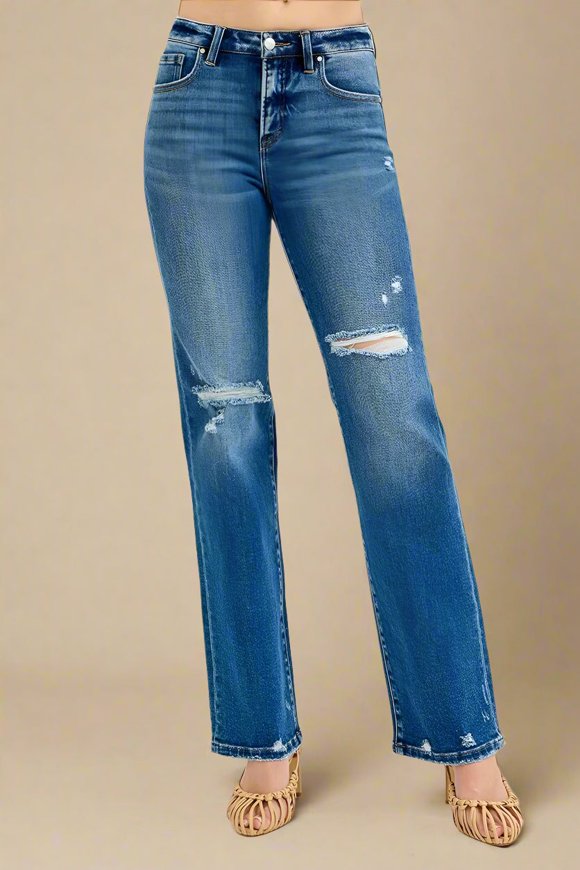 Blue jeans with slight distressing on a white background