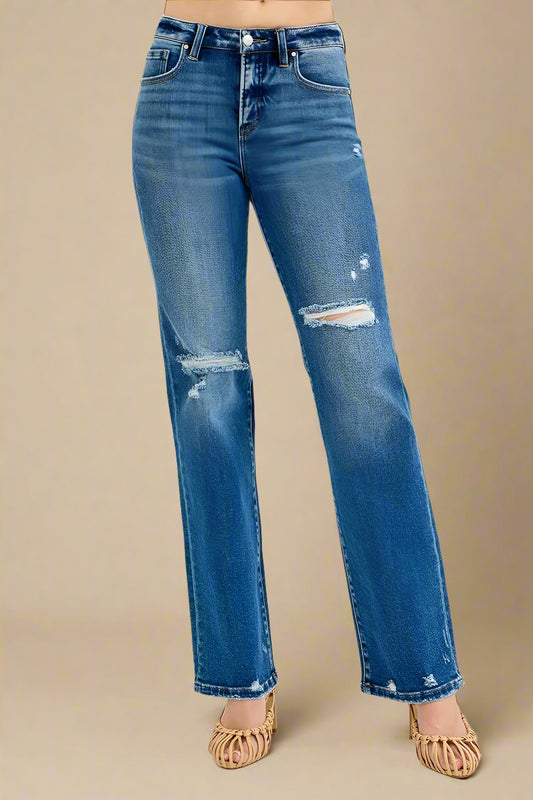 Blue jeans with slight distressing on a white background