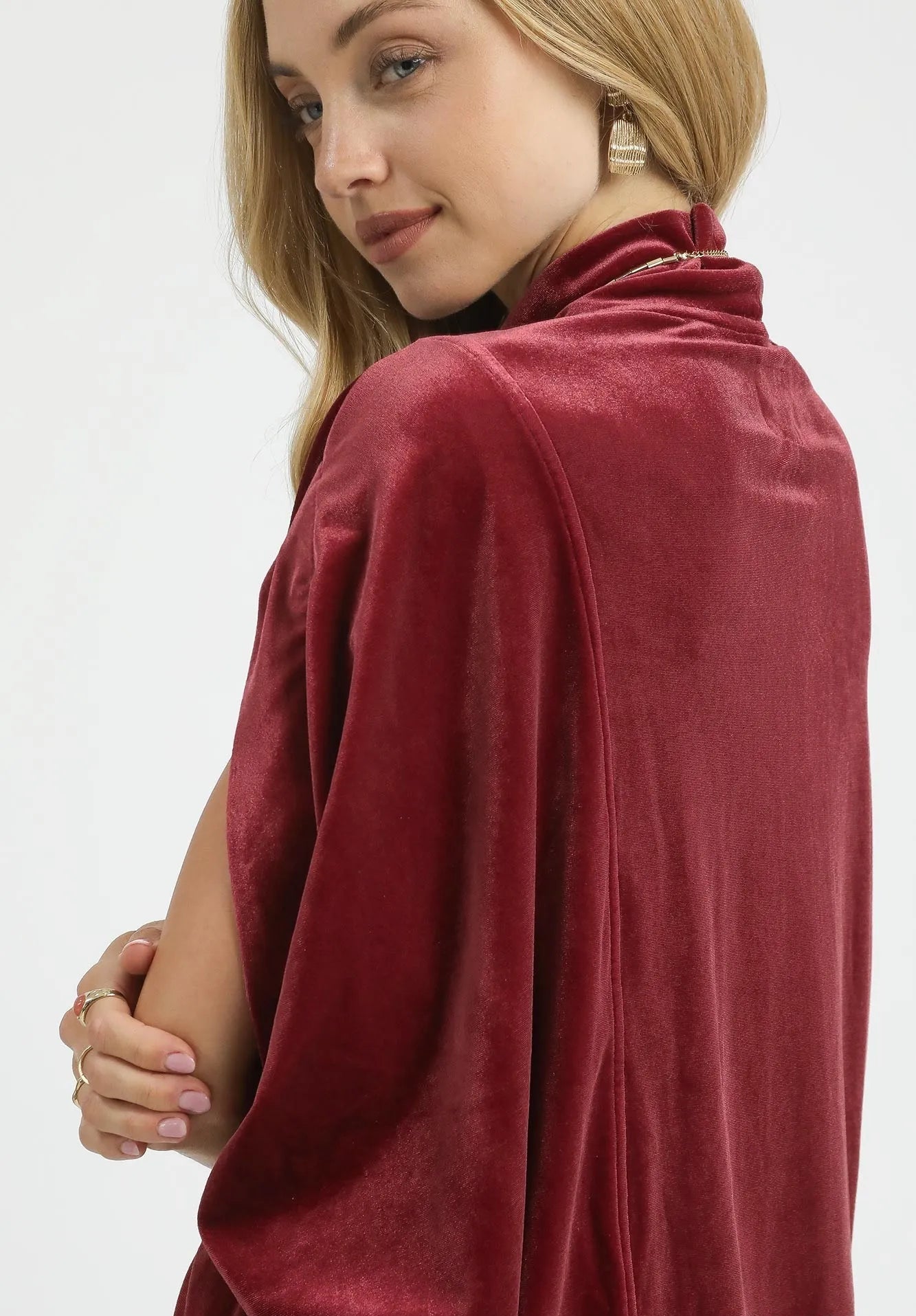 Woman wearing a burgundy top with on a white background