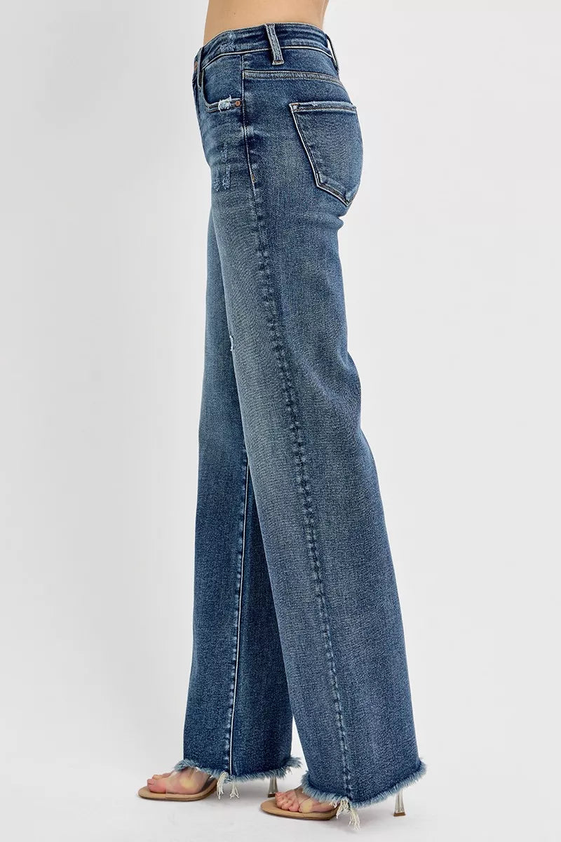 Blue jeans worn by a person on a white background