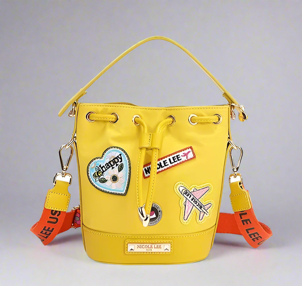 Yellow bucket bag with patches and drawstrings on a white background