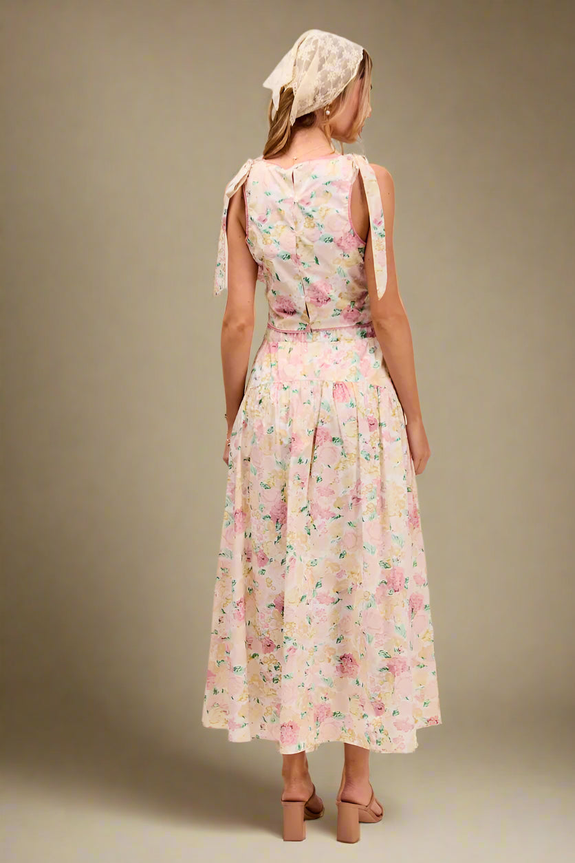 Woman wearing a floral dress with a plain background