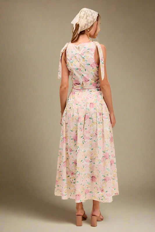 Woman wearing a floral dress with a plain background