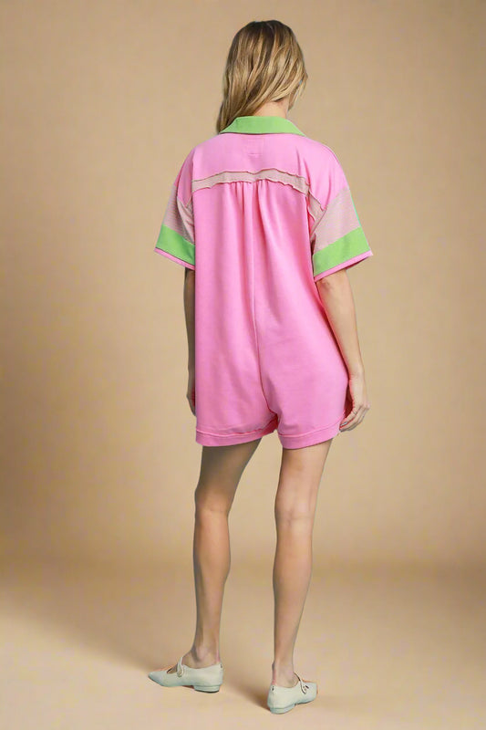 Person wearing a pink outfit with green accents on a beige background
