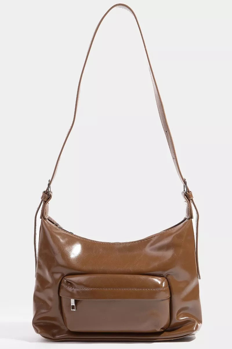Brown leather handbag with a strap on a white background
