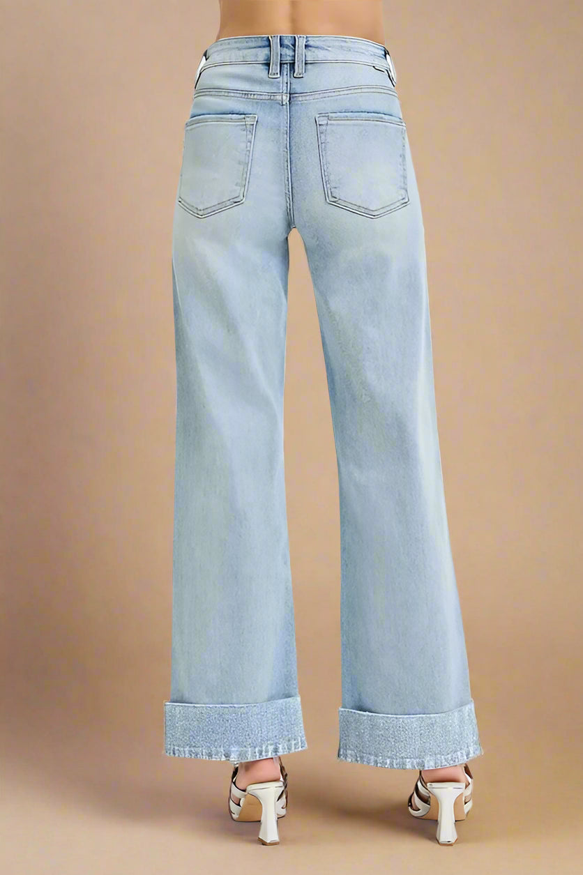 Light blue wide-leg jeans on a beige background