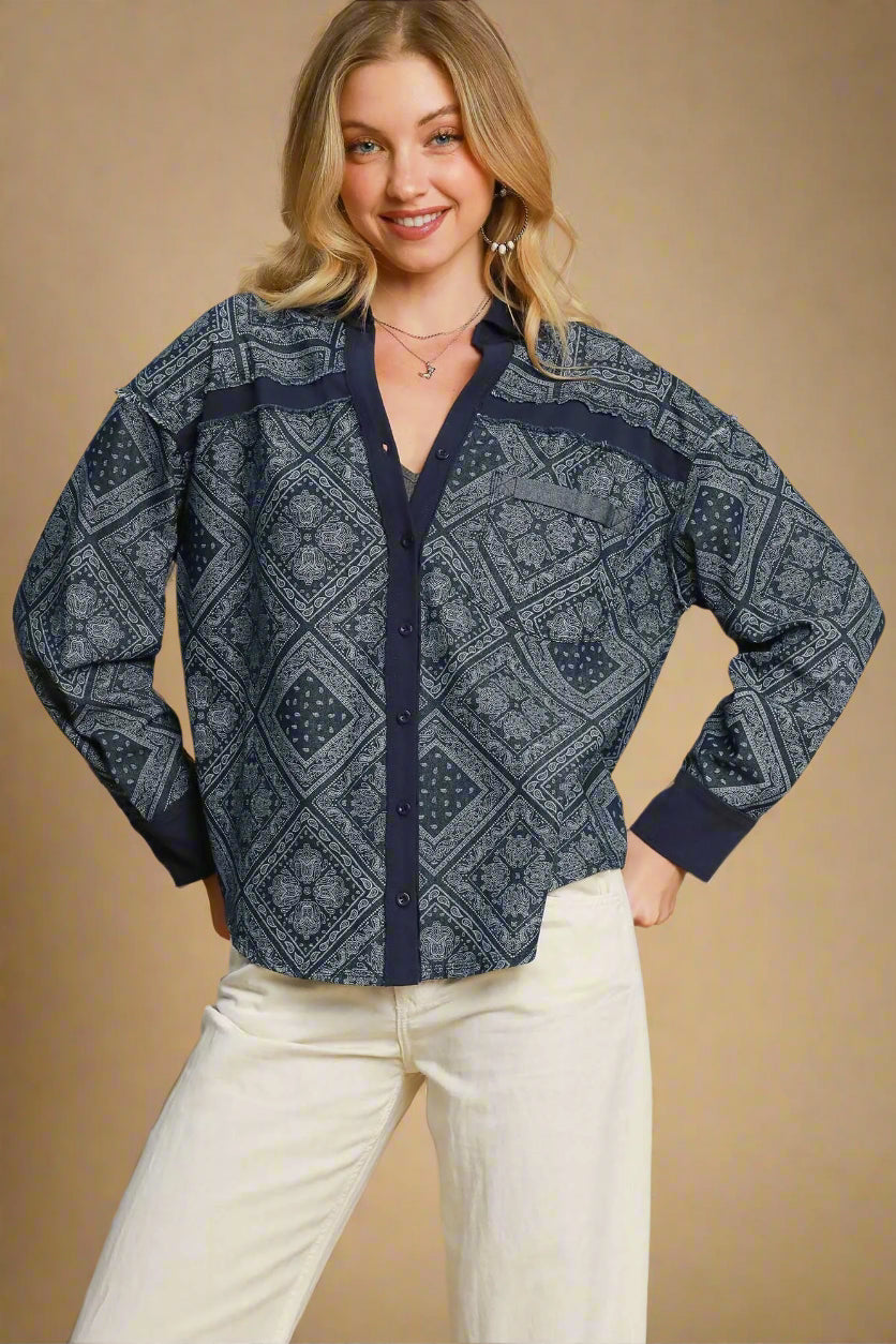 Woman wearing a dark denim patterned jacket against a beige background