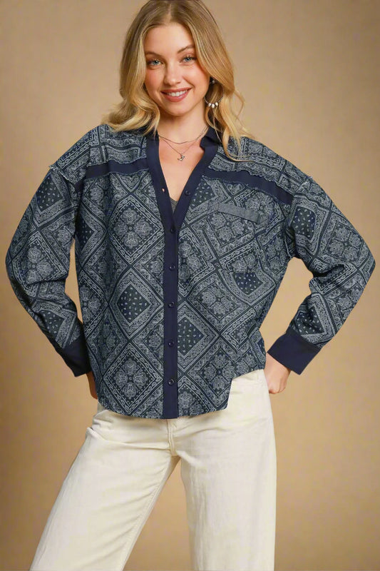 Woman wearing a dark denim patterned jacket against a beige background