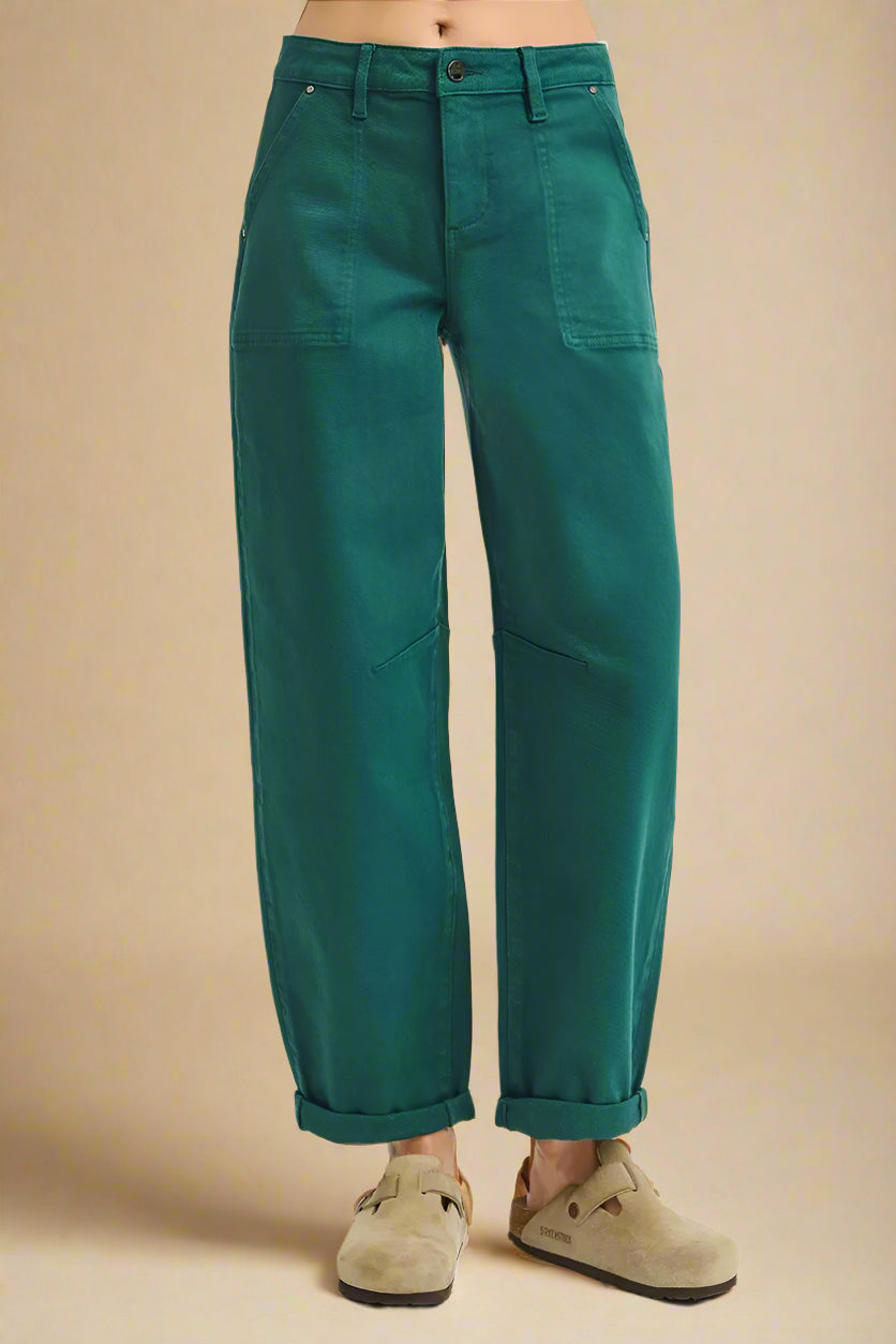 Green pants worn by a person on a white background
