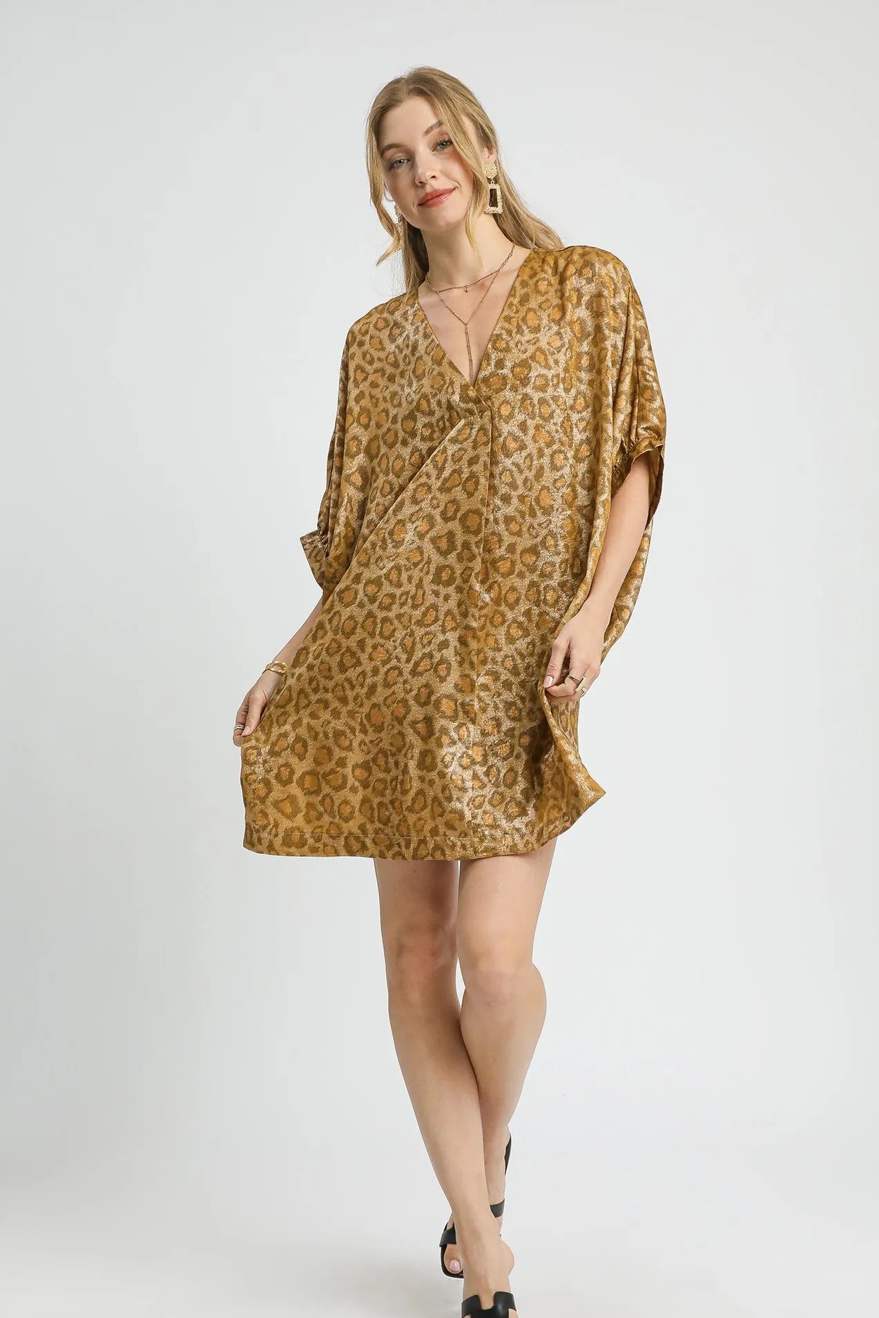 Woman wearing a brown leopard print dress on a white background