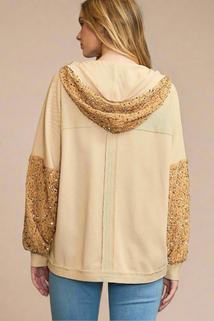 Beige hoodie with sequin details on a beige background