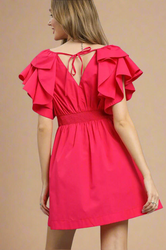 Red dress with ruffled sleeves on a gray background