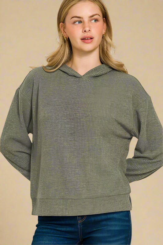 Woman wearing a dark olive hoodie on a white background