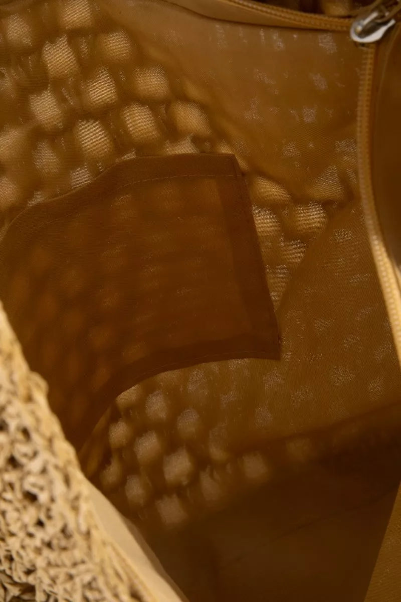 Close-up of a textured brown fabric with a patterned background