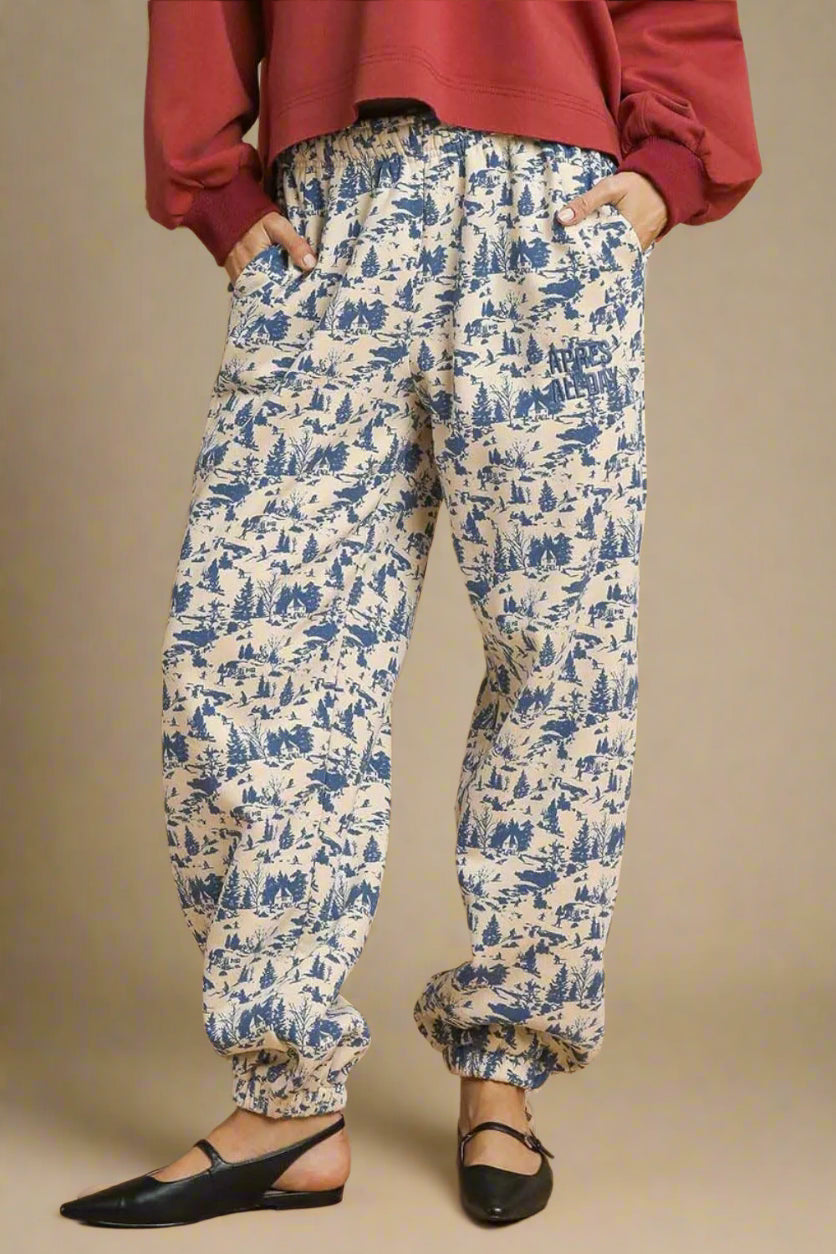 White pants with blue pattern worn by a person on a beige background