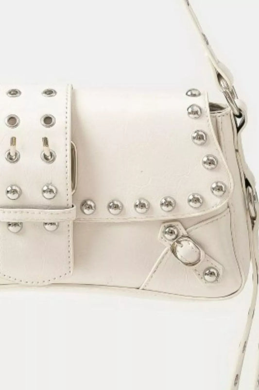 White handbag with silver studs on a white background