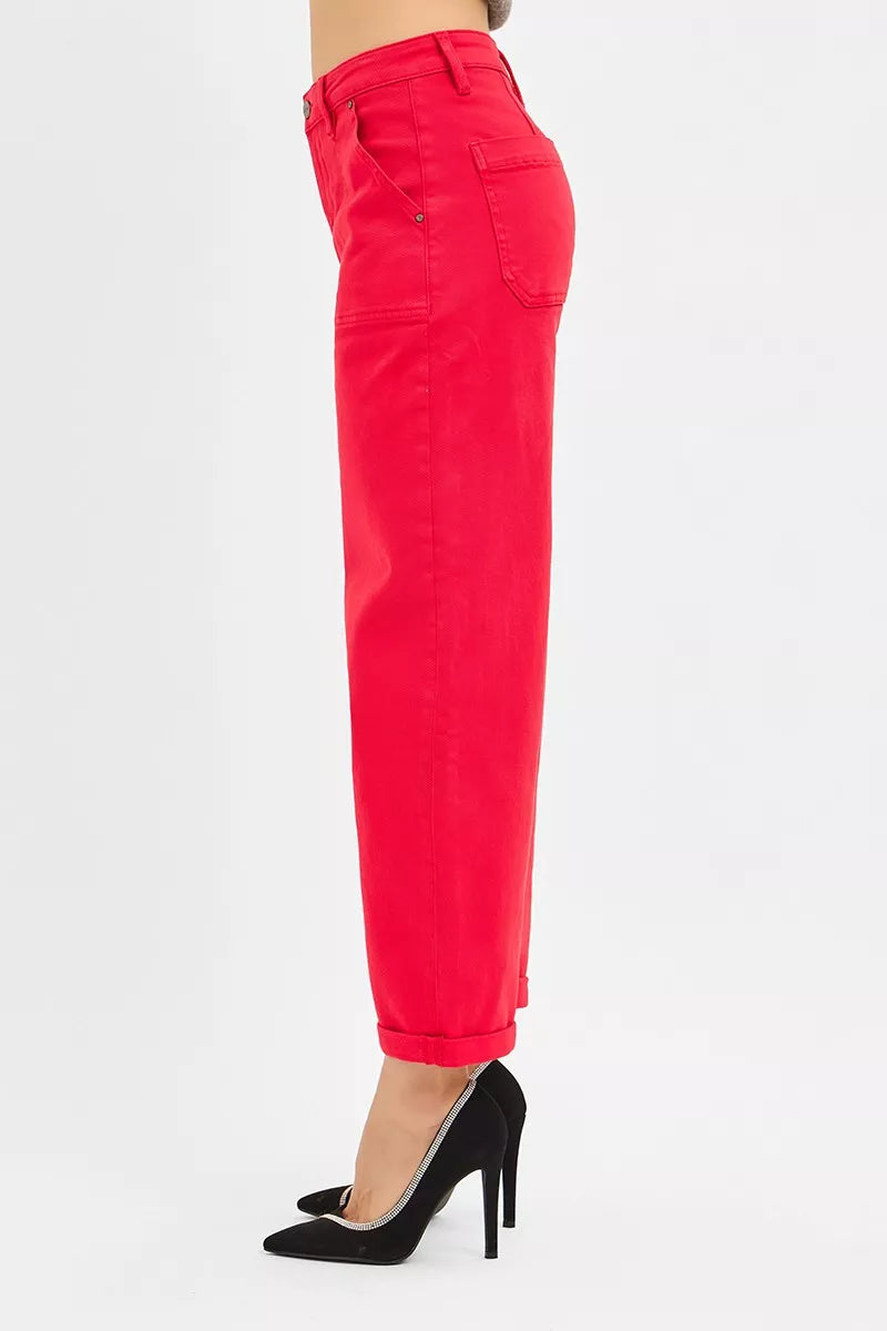 Red pants worn by a person on a white background