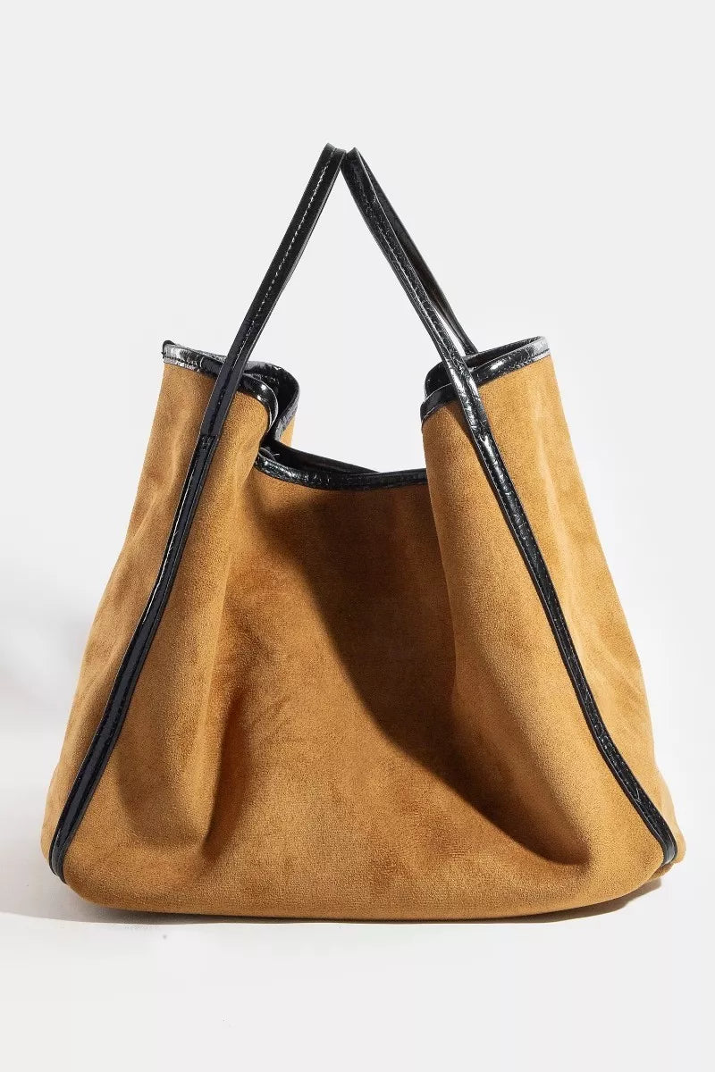 Brown handbag with black accents on a white background