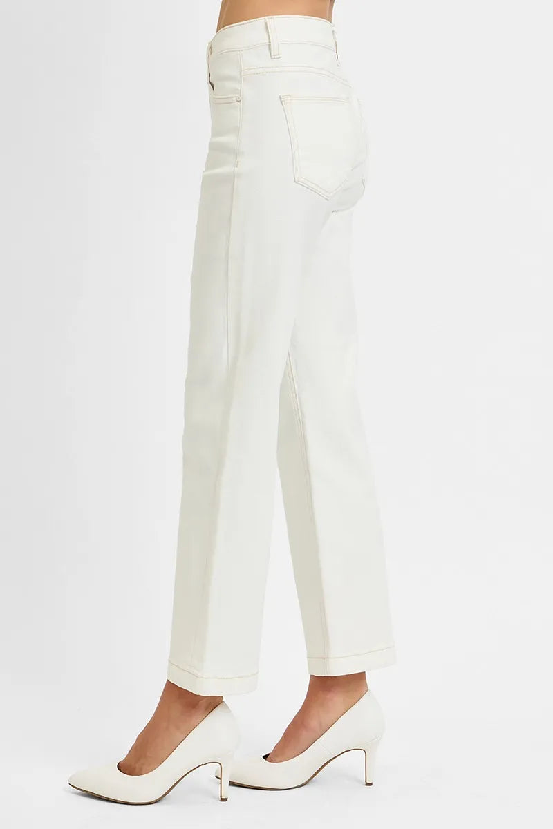 White pants worn by a person on a white background