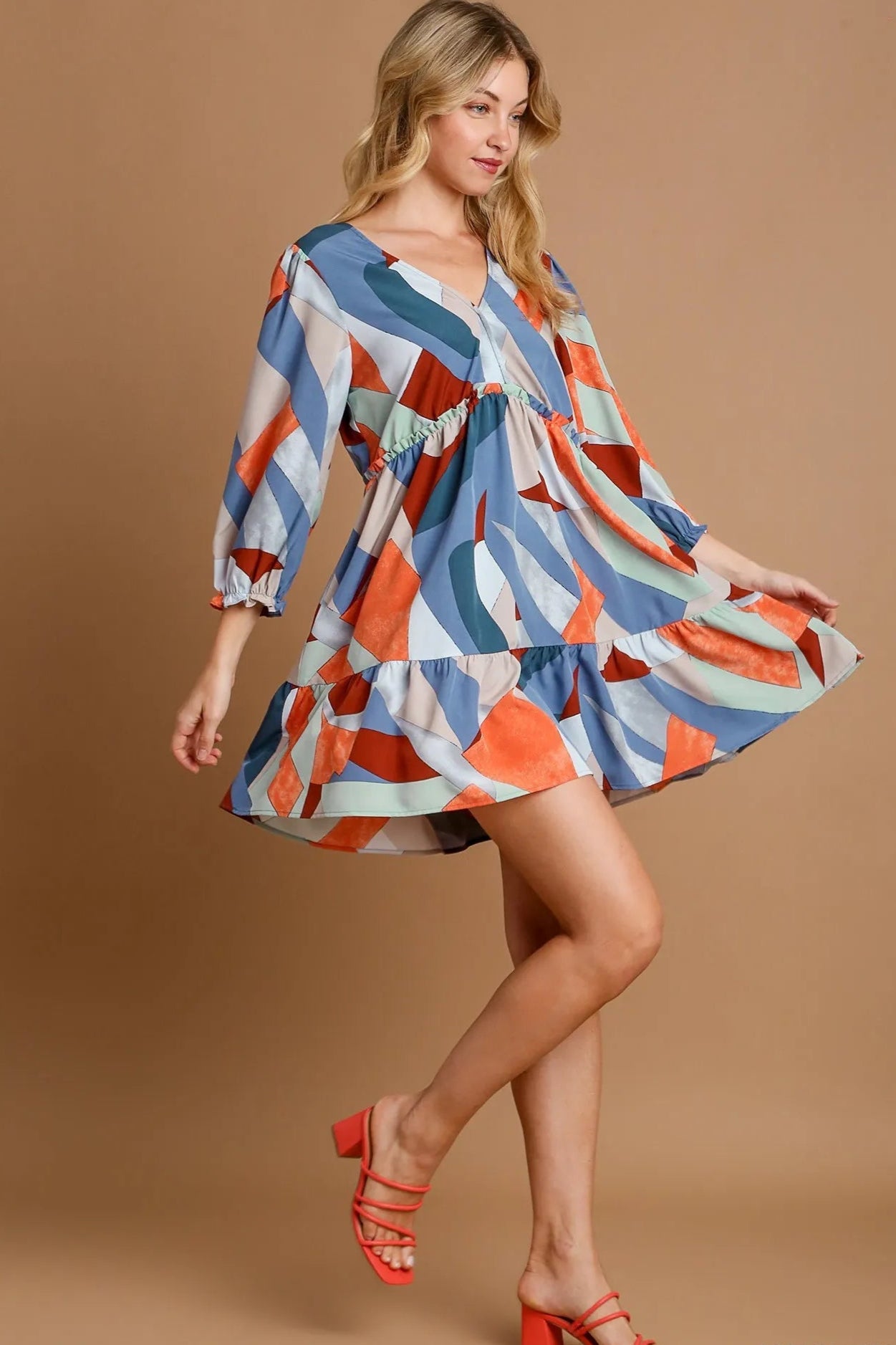 Woman wearing a colorful dress with a brown background