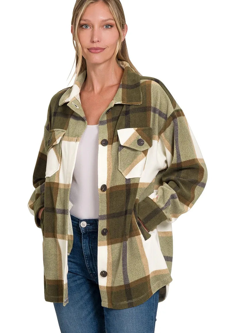 Woman wearing a plaid shirt with a white background