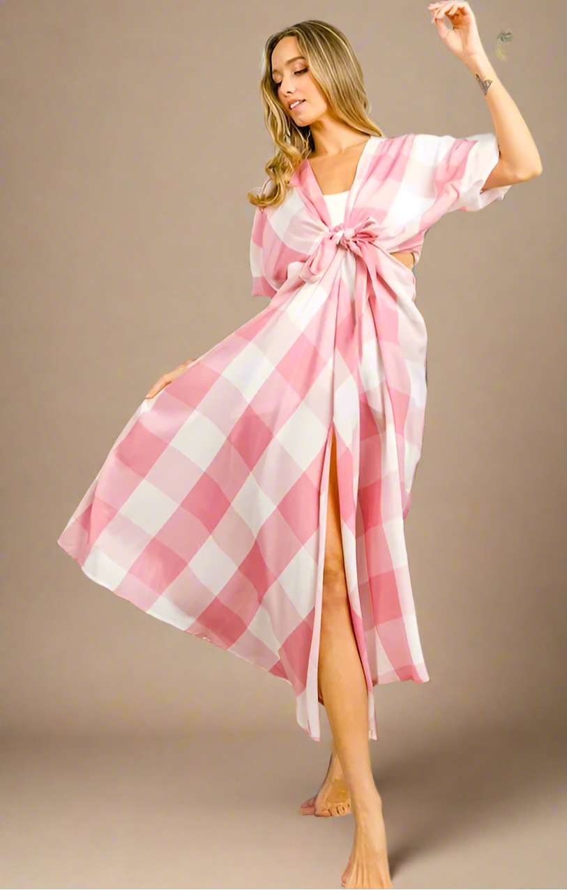 Woman wearing a pink and white checkered dress on a beige background