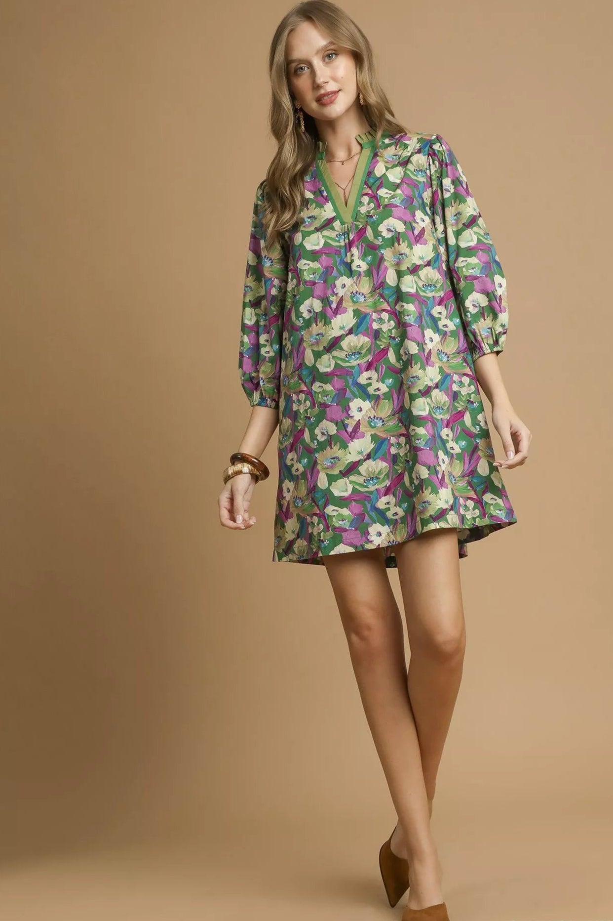 Woman wearing a floral dress on a beige background