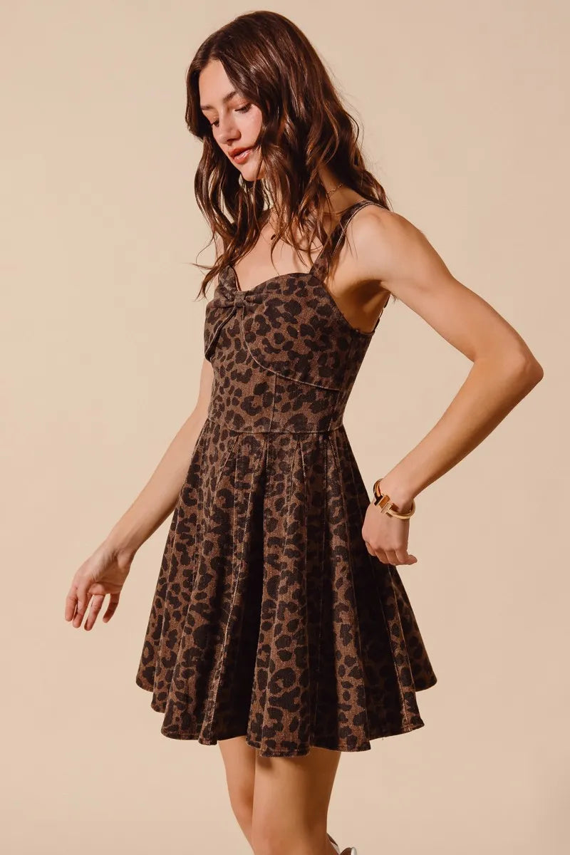 Woman wearing a leopard print dress against a beige background