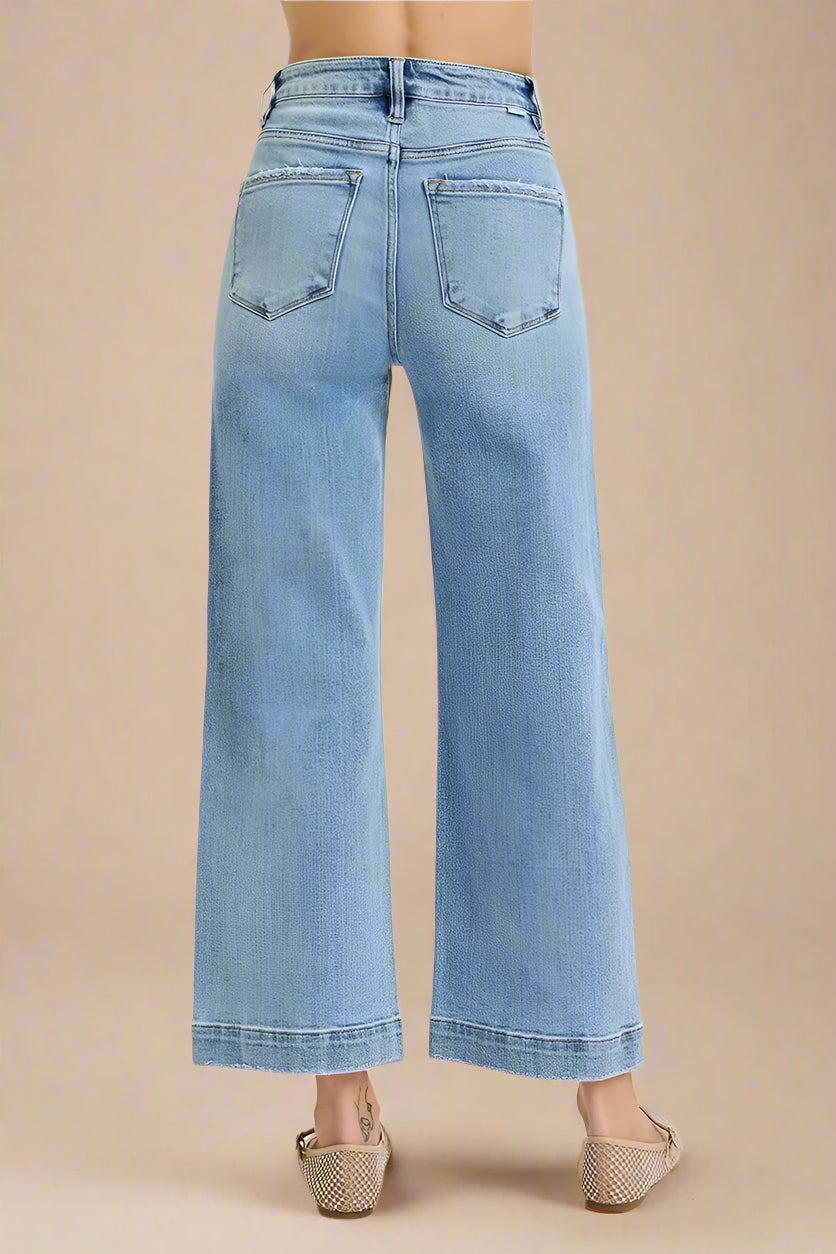 Light blue jeans worn by a person on a white background