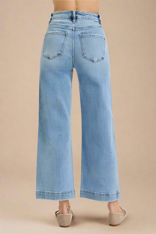 Light blue jeans worn by a person on a white background