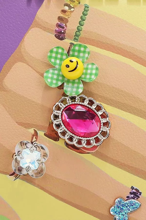 Colorful charm bracelet with various charms on a multicolored background