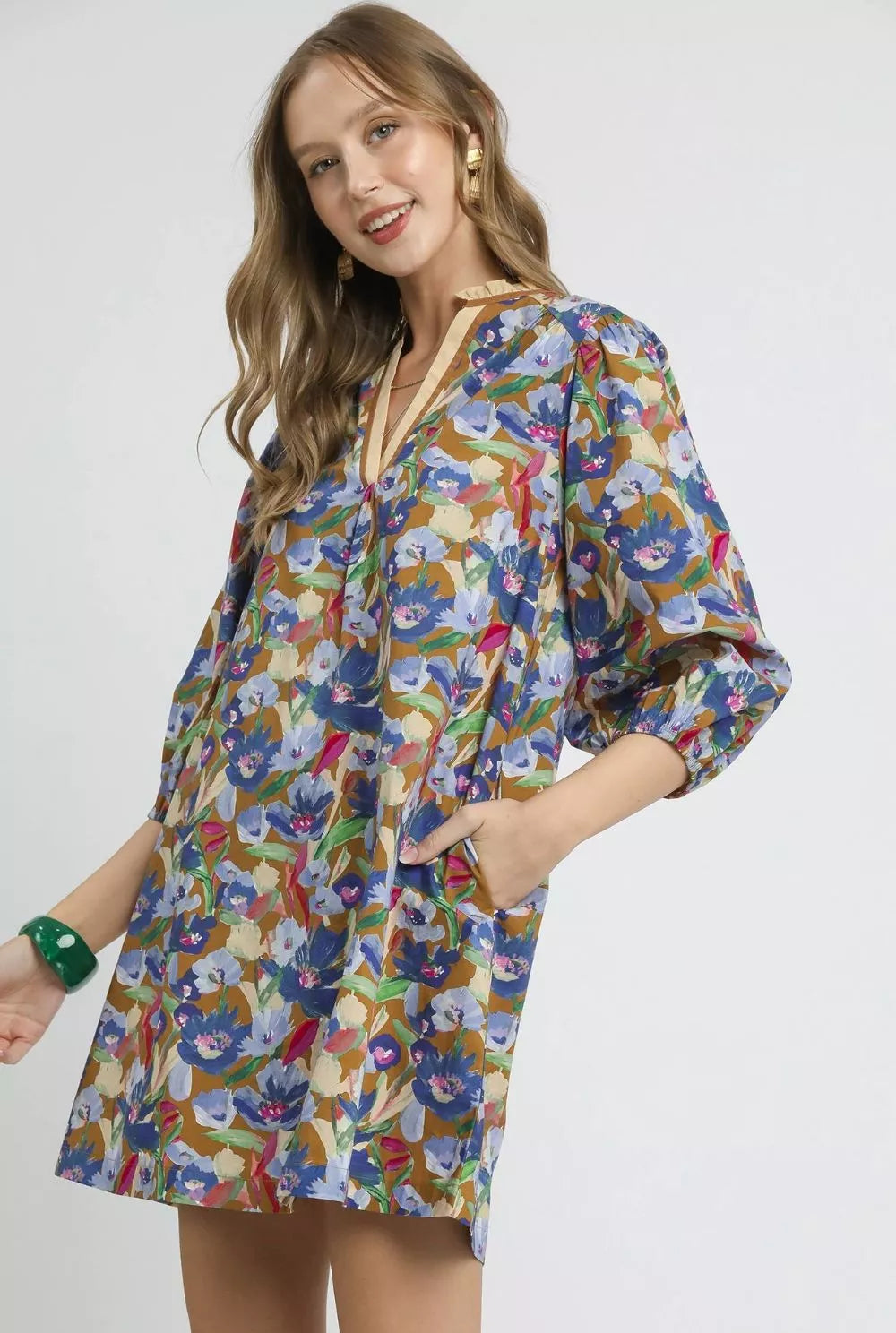 Woman wearing a colorful floral dress on a white background