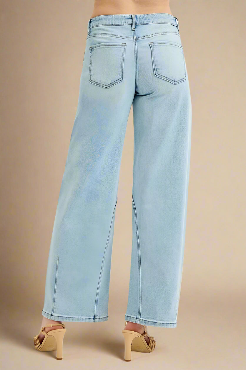 Light blue jeans worn by a person on a white background