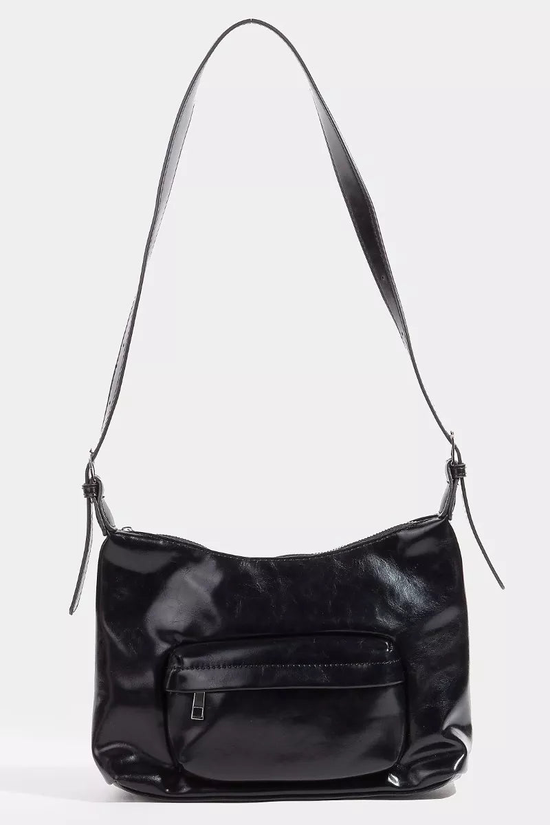 Black leather handbag with a shoulder strap on a white background